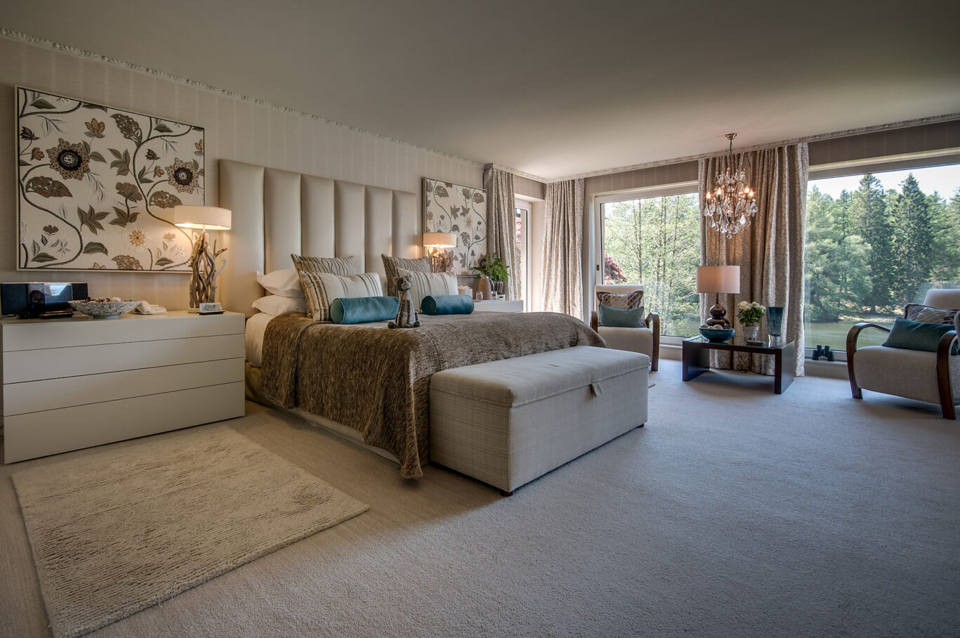 Harriet Room at Gilpin Lake House with a king-size bed, spacious seating area and large windows overlooking the woodland grounds.