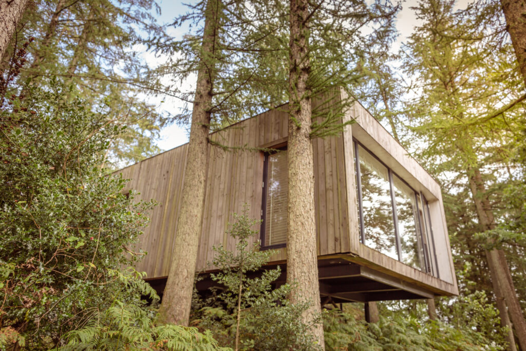 Gilpin Lake House’s Jetty Spa, a contemporary timber-clad treatment room set among tall trees and woodland.