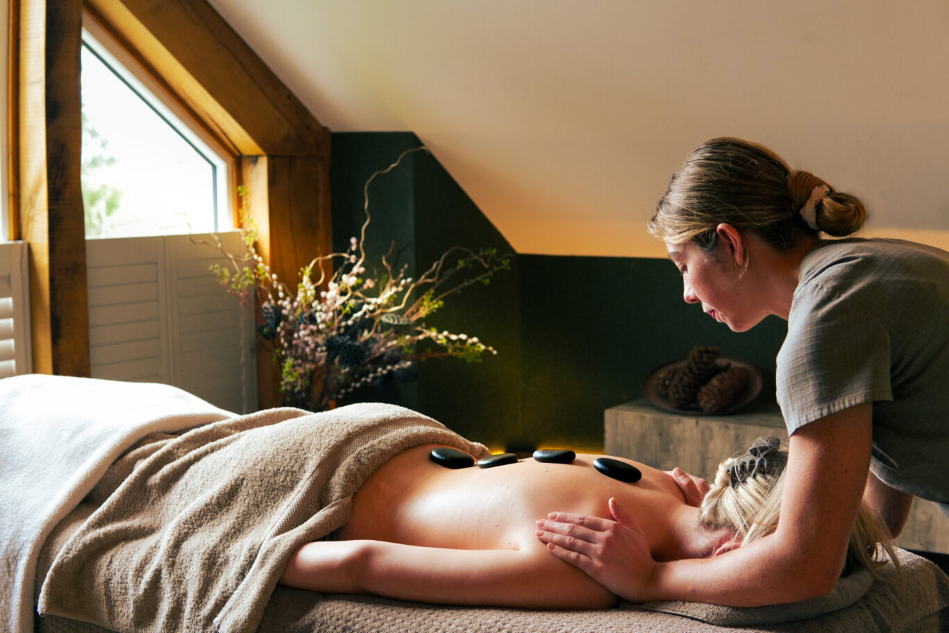 Spa therapist giving a relaxing massage treatment to a guest at Gilpin.