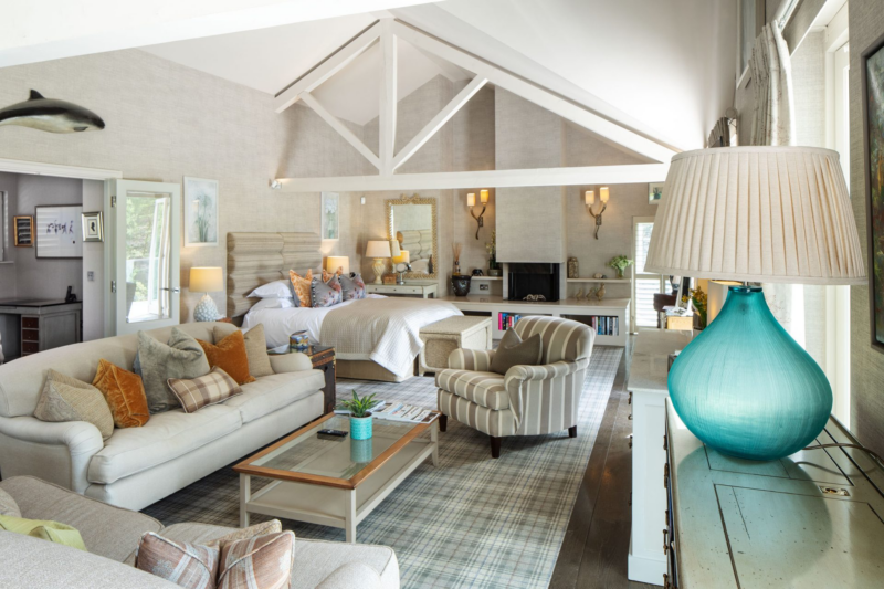 Knipe Spa Suite at Gilpin Lake House with a spacious open-plan bedroom and lounge, vaulted ceiling and comfortable seating.
