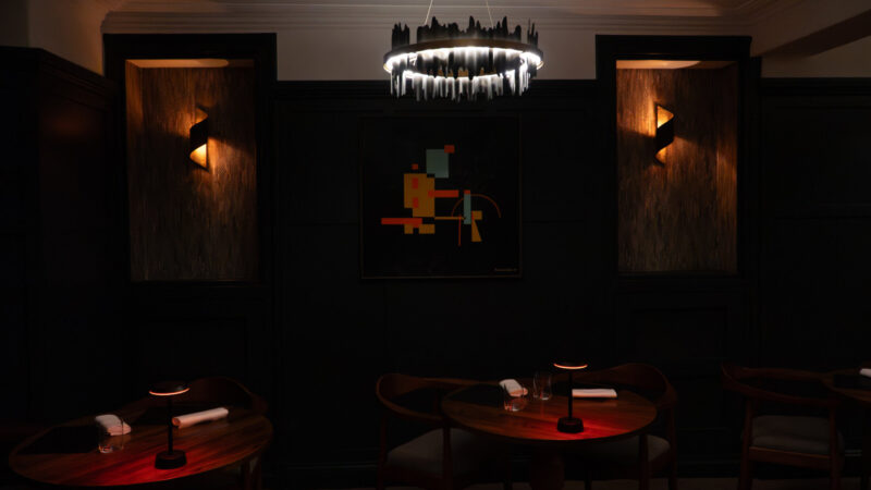 SOURCE dining room at Gilpin Hotel, with intimate tables, dark interiors and warm ambient lighting.