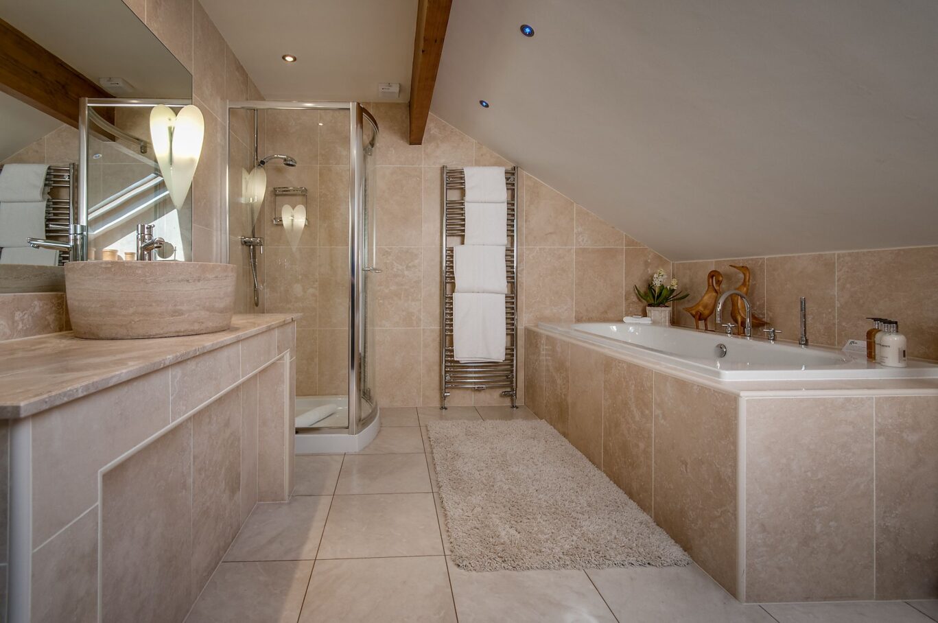 Beatrice Room bathroom at Gilpin Lake House with a large tiled bath, walk-in shower and spacious vanity area.