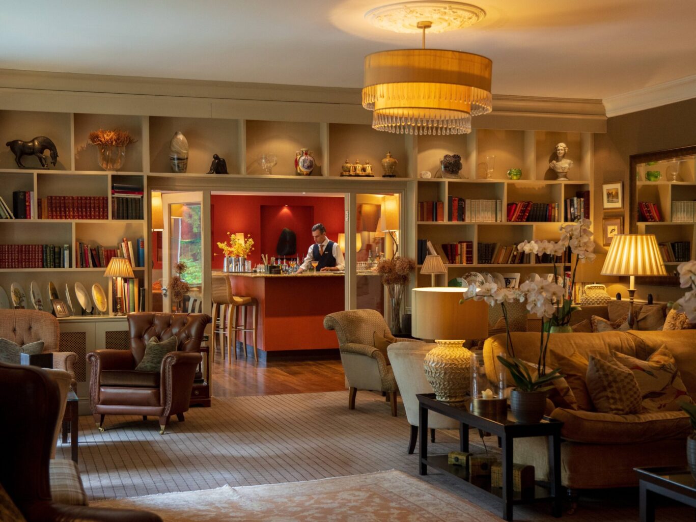 Cosy lounge at Gilpin Hotel with comfortable seating, warm lighting and a welcoming fireside atmosphere.