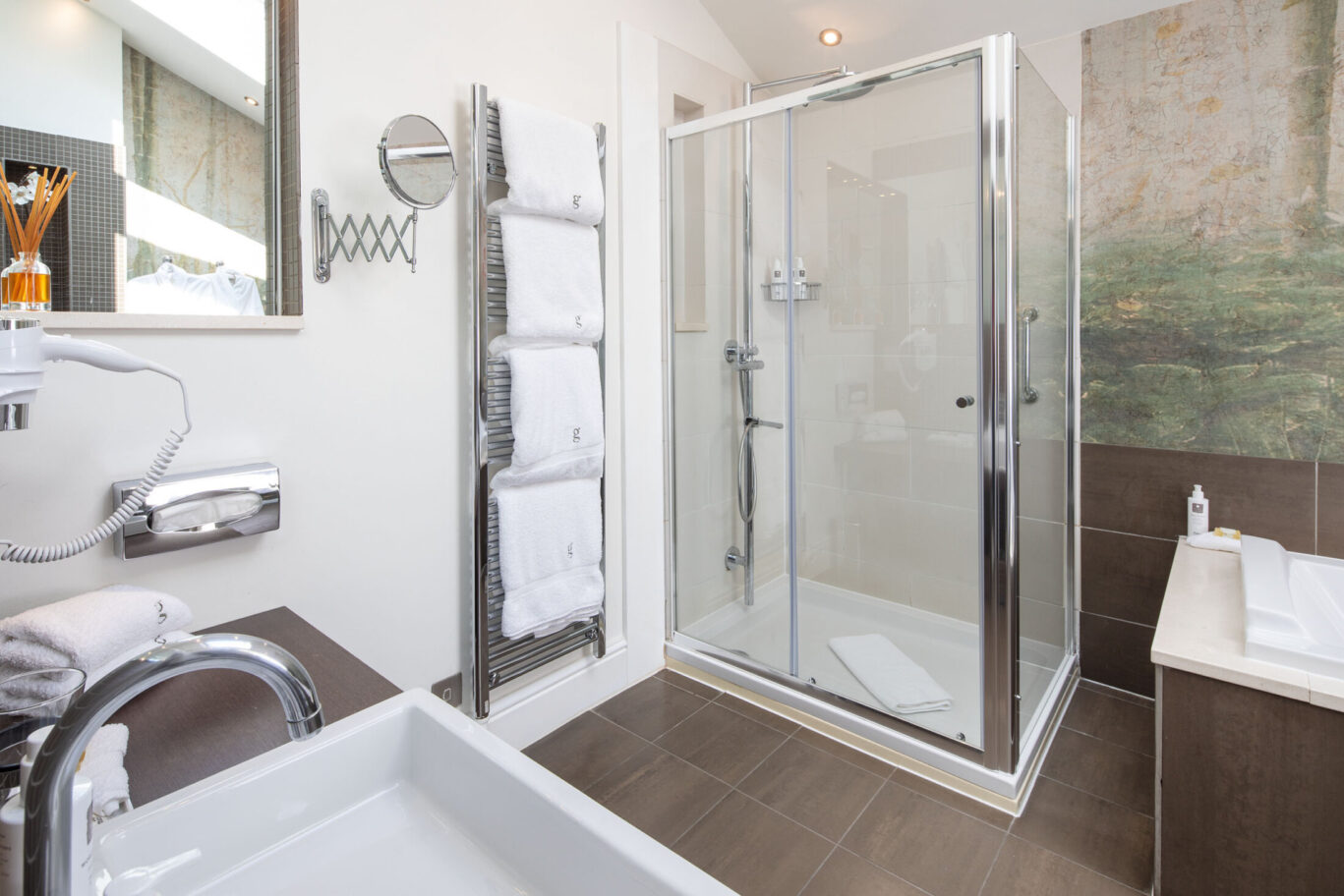 Crinkle Crags Garden Suite bathroom at Gilpin Hotel with a large walk-in shower and contemporary interiors.
