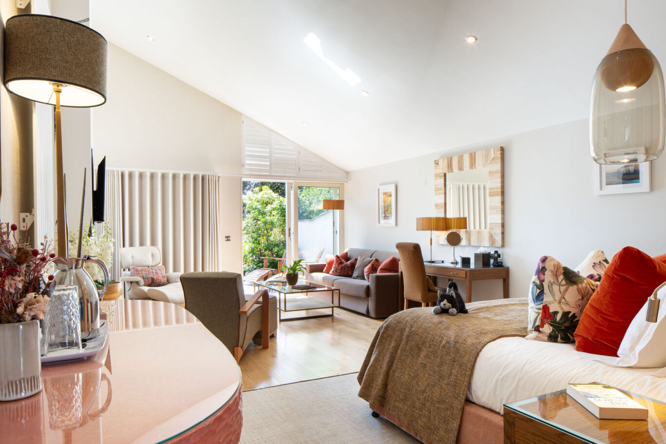 Crinkle Crags Garden Suite at Gilpin Hotel with a spacious bedroom, lounge area and doors opening onto the garden.