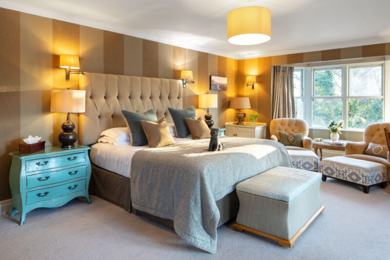 Gilpin Hotel Junior Suite with a king-size bed, elegant furnishings and a comfortable seating area overlooking the gardens.