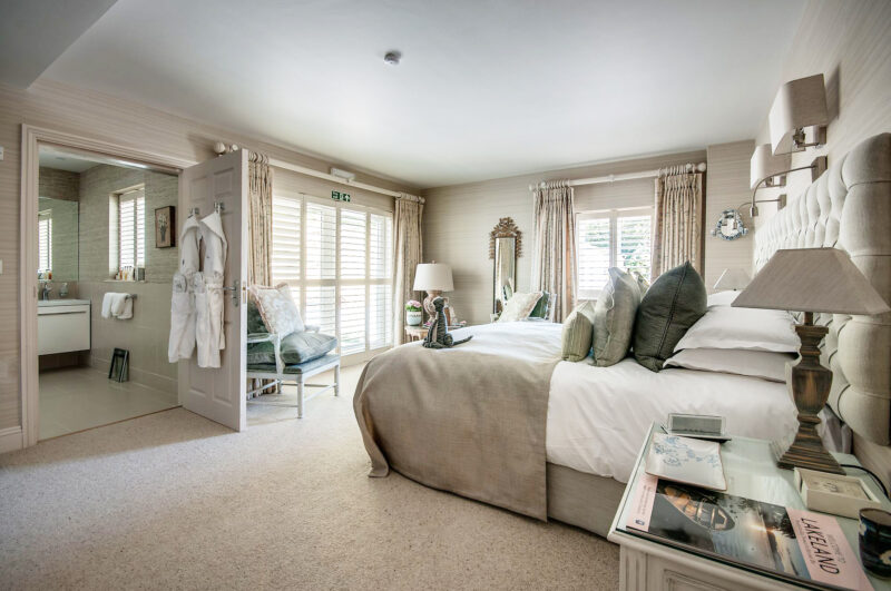 Classic Room at Gilpin Lake House with a king-size bed, soft neutral furnishings and French doors opening onto the garden.