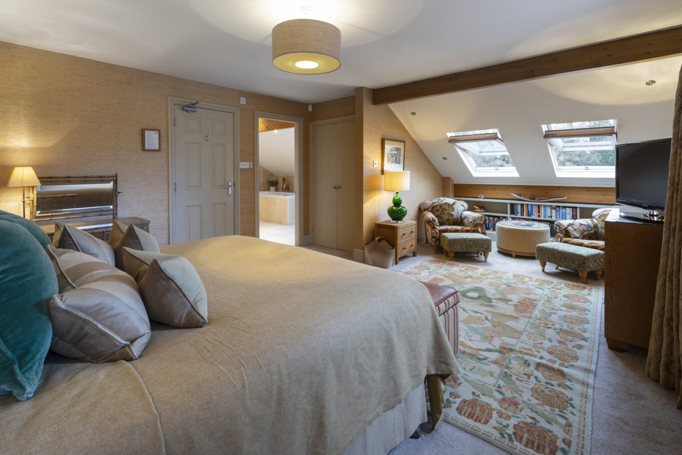 Beatrice Room at Gilpin Lake House with a spacious bedroom, king-size bed, comfortable seating area and skylights.