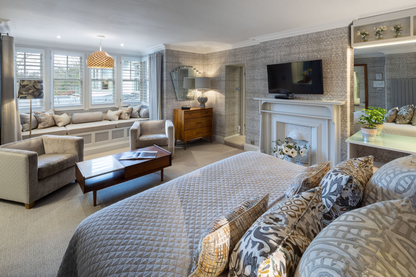 Cleabarrow Master Room at Gilpin Hotel with a king-size bed, spacious seating area, feature fireplace and window seat.