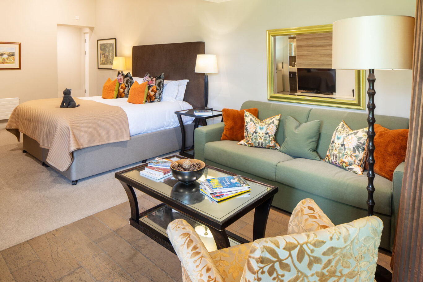 St Sunday Crag Garden Suite at Gilpin Hotel with a king-size bed, comfortable lounge area and colourful botanical details.