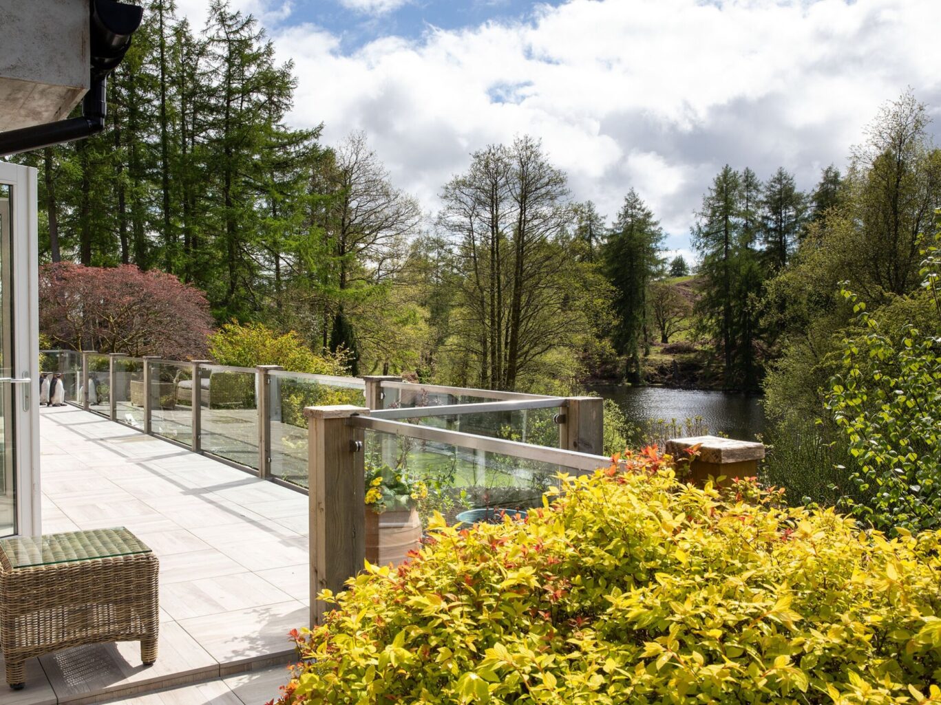 Private terrace at Gilpin Lake House overlooking the lake and surrounding woodland.