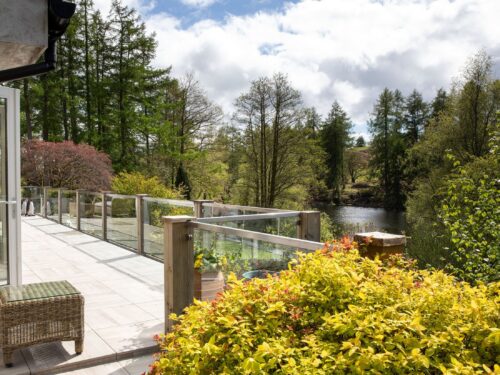 Private terrace at Gilpin Lake House overlooking the lake and surrounding woodland.