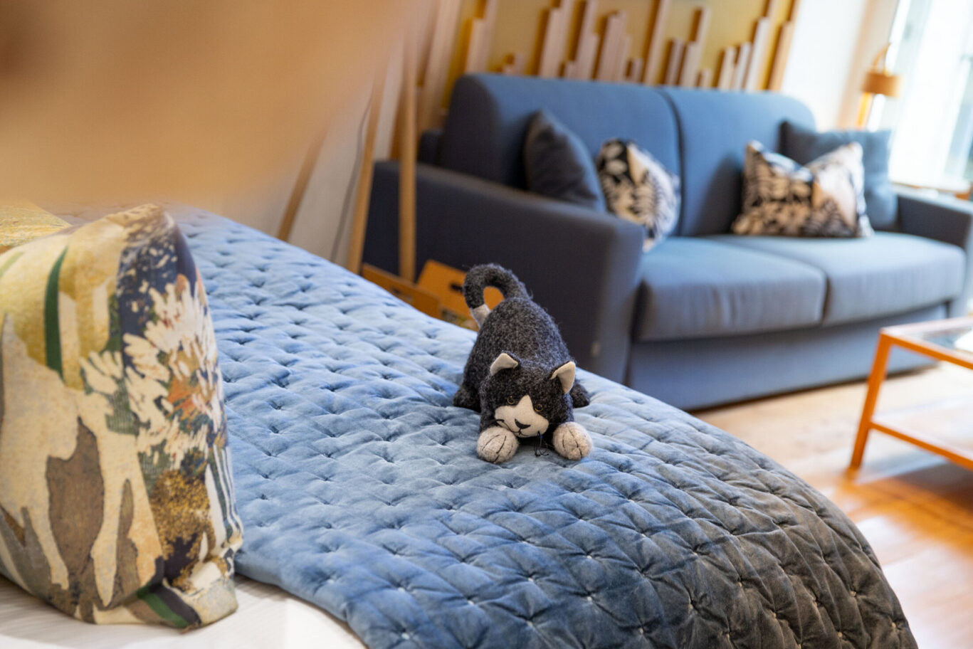 Garden Suite at Gilpin Hotel with a blue quilted bed, floral furnishings and signature cat detail.