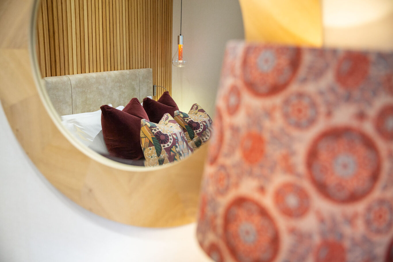 Garden Suite at Gilpin Hotel with warm timber details, patterned soft furnishings and a contemporary bedroom design.