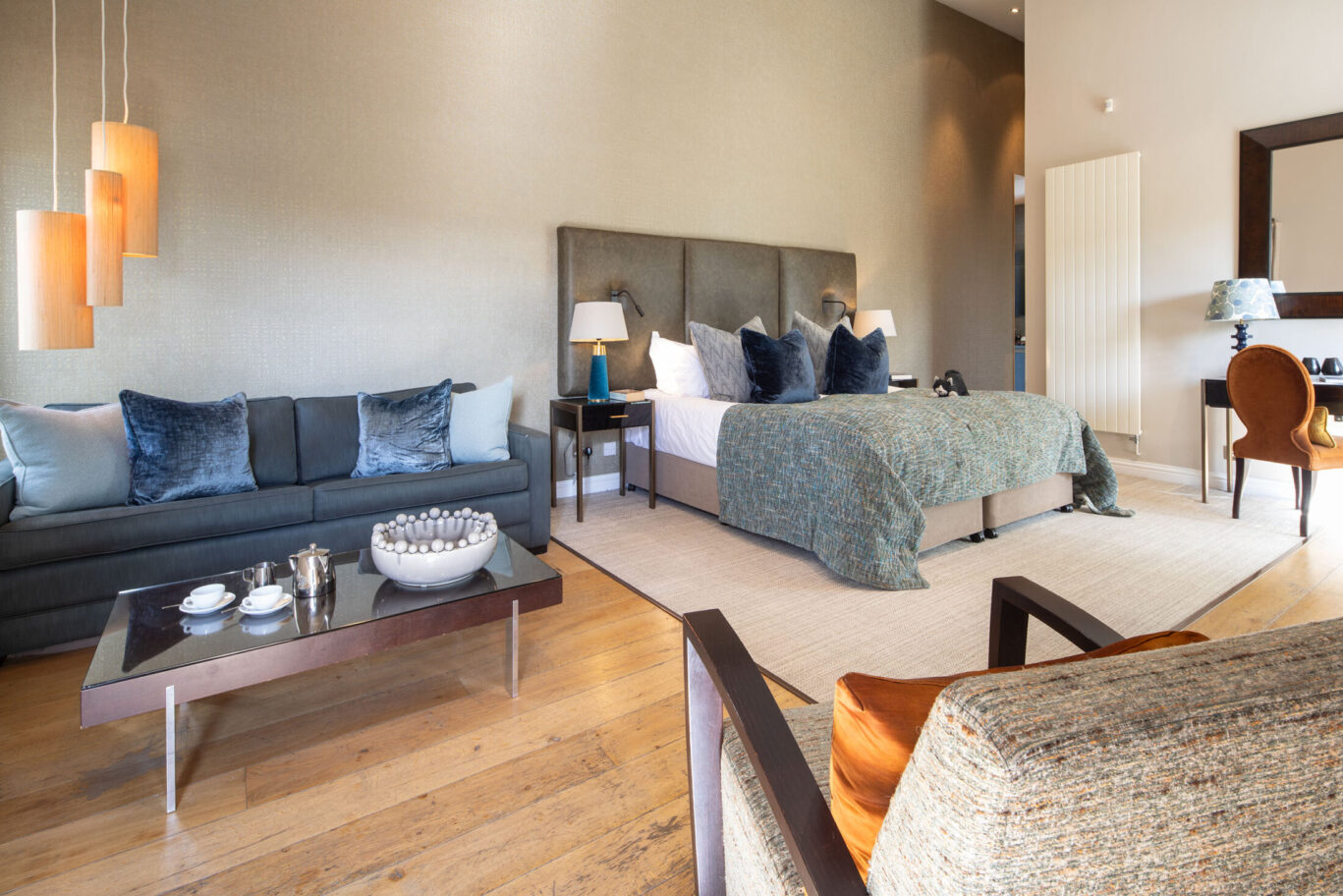 Garden Suite at Gilpin Hotel with a spacious king-size bed, contemporary lounge area and soft blue and neutral furnishings.