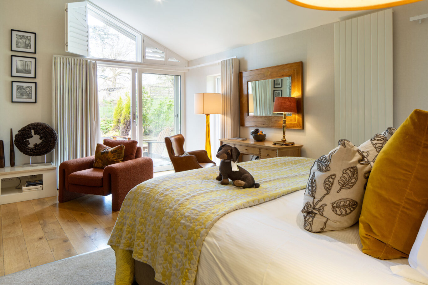 Garden Suite at Gilpin Hotel with a king-size bed, comfortable seating area and warm contemporary interiors.