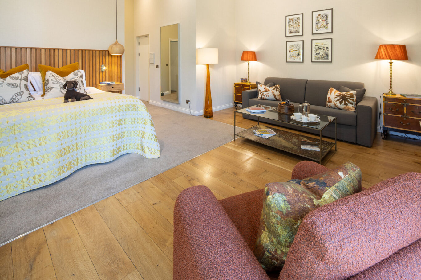 Bright Garden Suite at Gilpin Hotel with a king-size bed, private seating area and doors opening towards the garden.