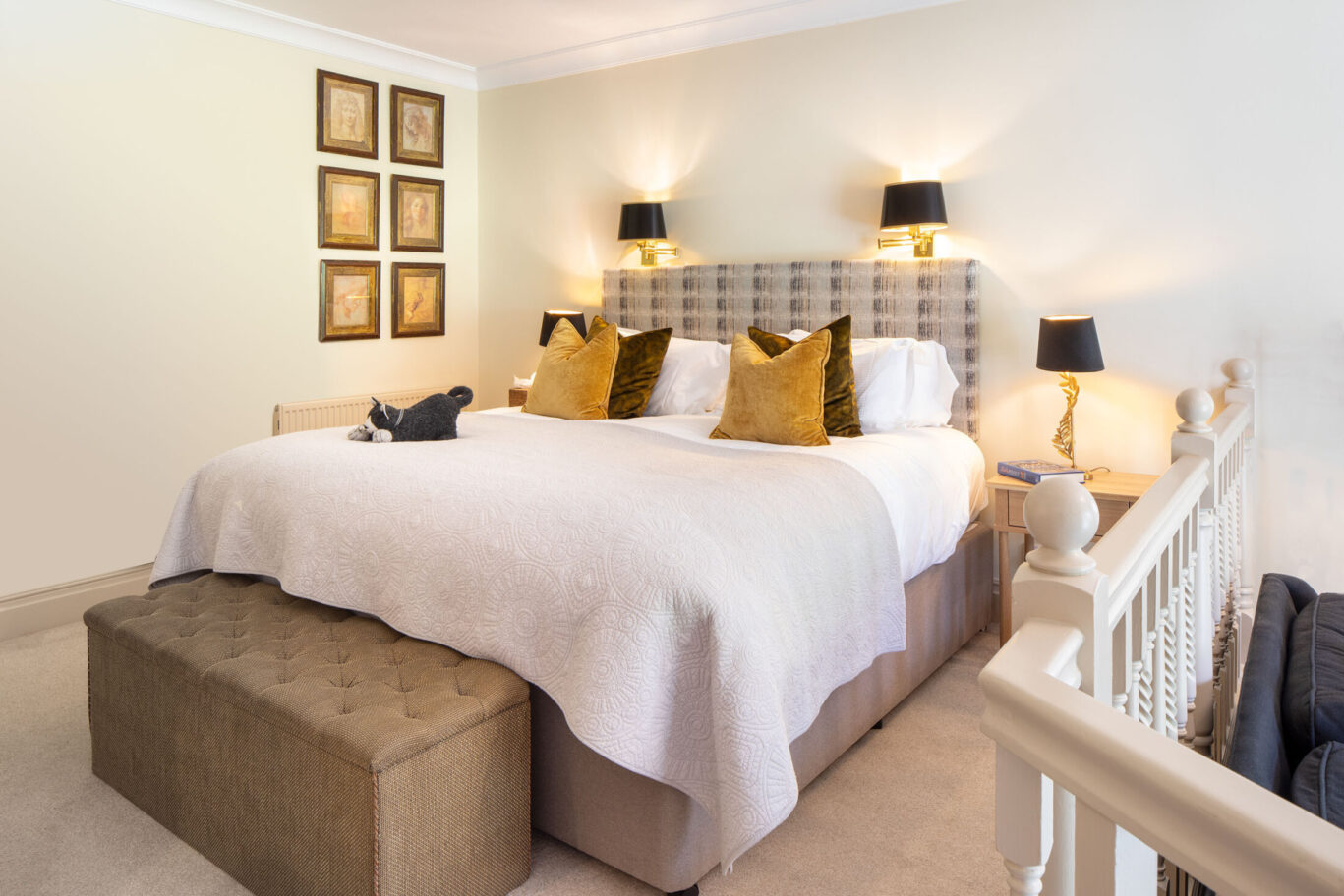 Junior Suite at Gilpin Hotel with a king-size bed, soft neutral décor and a split-level layout overlooking the lounge area.